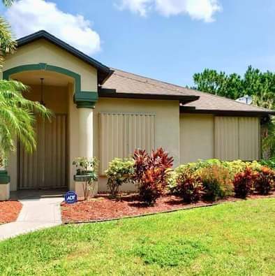 Accordion shutters on windows from front view of house