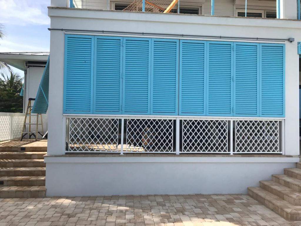 Aqua Blue colonial shutters closed