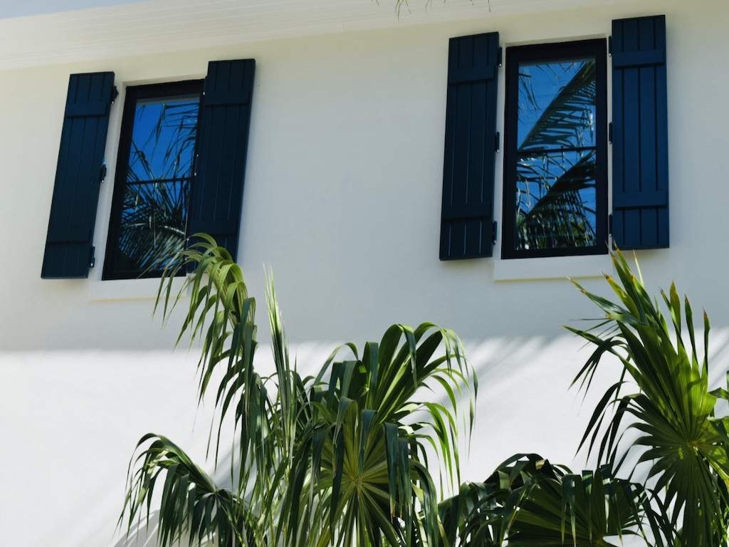 Black colonial shutters on a cream colored house