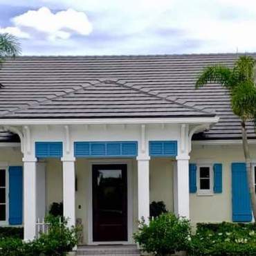 Blue Roll Down Shutters on Front Porch with White Columns
