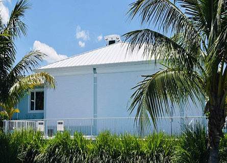 closed roll down shutters on light blue house