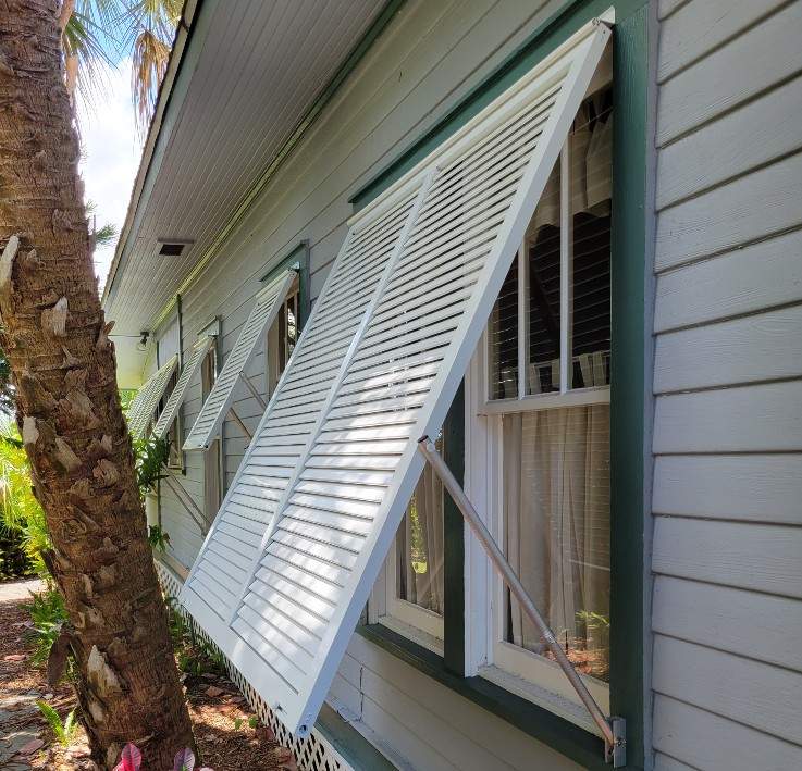 White bahamam shutters on side of house