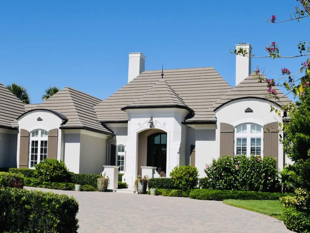 brown colonial shutters on an off white house