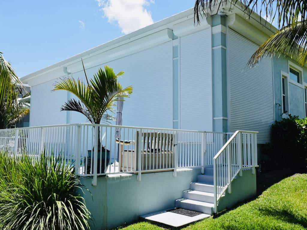 Custom fabrication of a white fence around pool deck