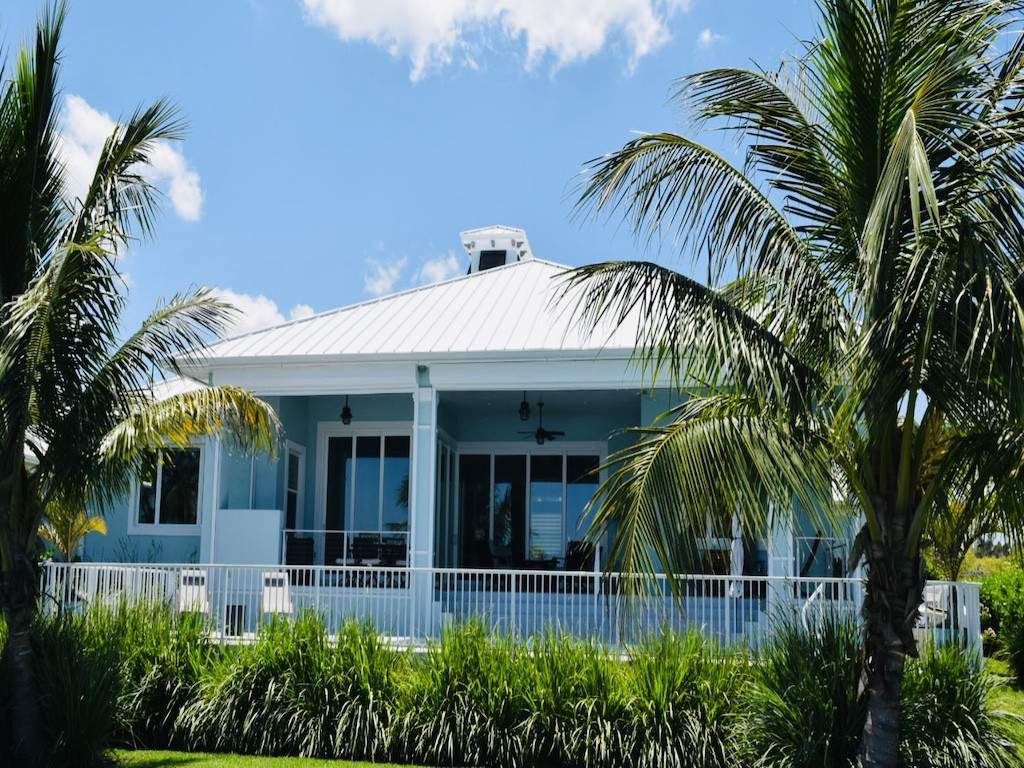 Custom white fence around back side of blue house